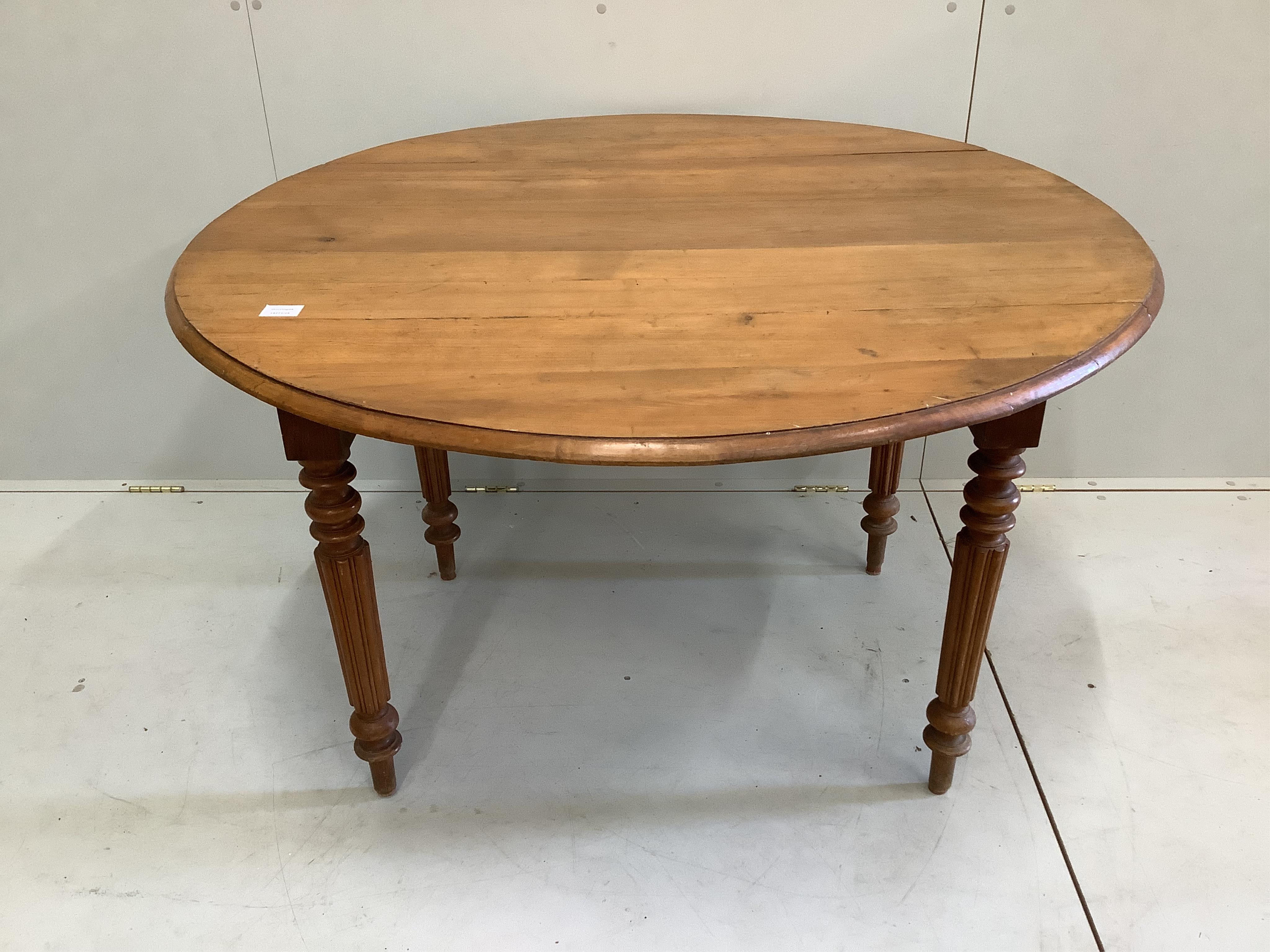 A 19th century French pine drop leaf kitchen table, width 118cm, depth 66cm, height 72cm